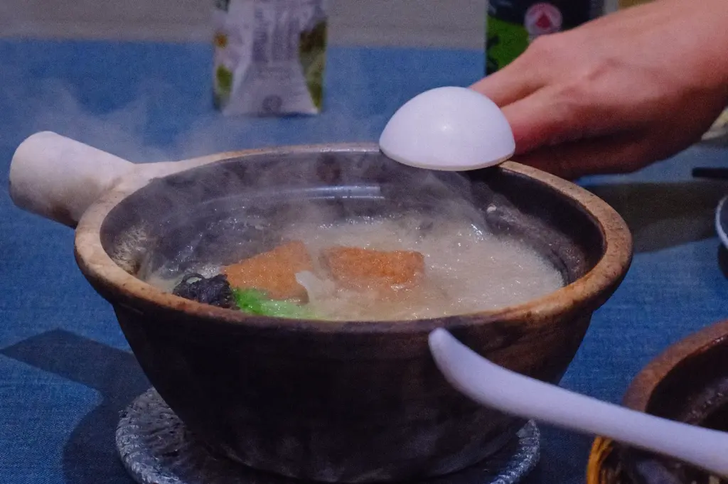 Steaming claypot Grandpa's Pomfret Fish Soup served with fresh fish, vegetables and collagen-rich broth, photographed from a slightly elevated dining-table angle highlighting balanced fish soup flavour and texture.